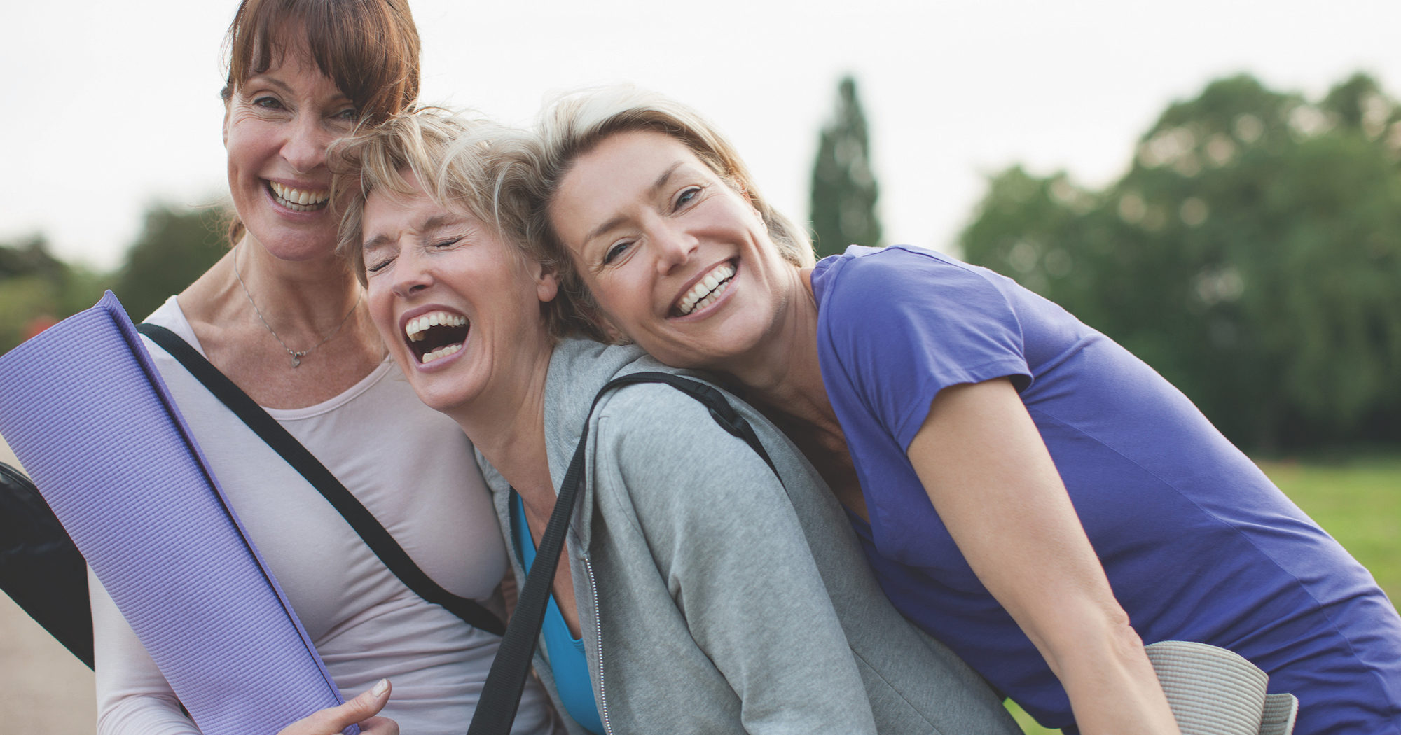 Smiling Women with Yoga Mats